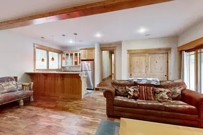 a living room with a couch and a kitchen at High Meadows Gem in South Lake Tahoe