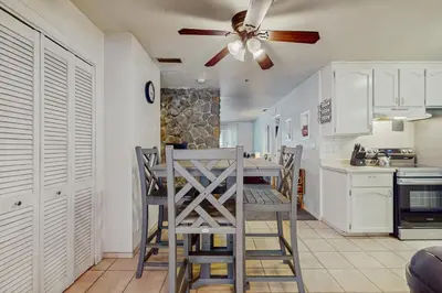 a kitchen with a ceiling fan and a table and chairs at Apache Adventures in South Lake Tahoe