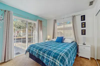 a bedroom with a bed and a large window at Apache Adventures in South Lake Tahoe
