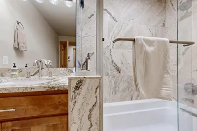 a bathroom with a shower and a tub and a sink at Oslo Oasis in Truckee