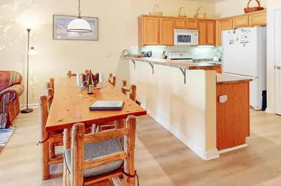 a kitchen with a wooden table and a refrigerator at The Boulders Bldg 2 Unit 3 in Truckee