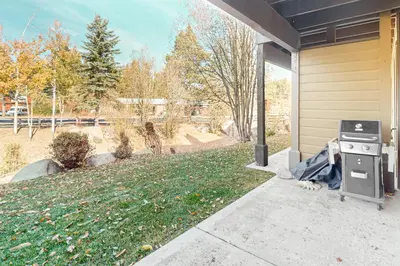 a grill sitting outside of a house with a yard at The Boulders Bldg 2 Unit 3 in Truckee