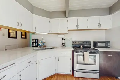 a kitchen with white cabinets and a stove top oven at Arrowhead Escape in South Lake Tahoe