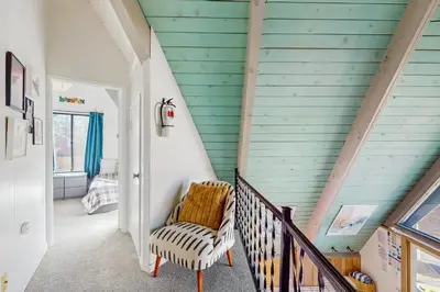 a staircase in a house with blue siding at Arrowhead Escape in South Lake Tahoe