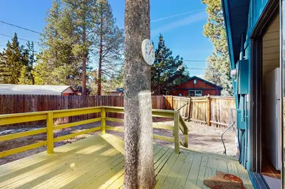a tree with a clock on the side of a porch at Arrowhead Escape in South Lake Tahoe