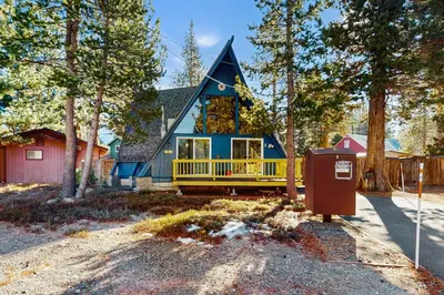 a blue and yellow house in the woods at Arrowhead Escape in South Lake Tahoe
