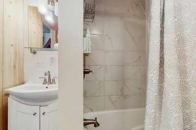 a white bathroom with a sink and a shower at Arrowhead Escape in South Lake Tahoe
