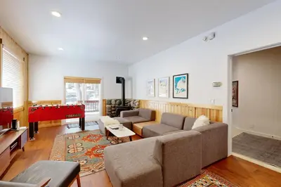a living room with a couch and a piano at Tyrol Getaway in Truckee