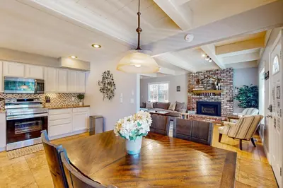 a kitchen and living room with a wooden dining table at Cougar Haven in South Lake Tahoe