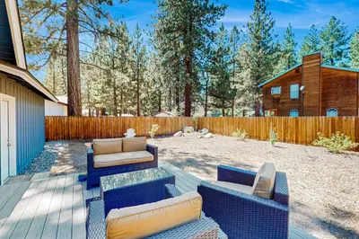 a patio with a couch and chairs in a yard at Cougar Haven in South Lake Tahoe