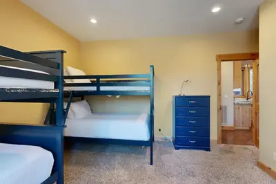 a bedroom with two bunk beds and a blue dresser at Marshall Escape in South Lake Tahoe
