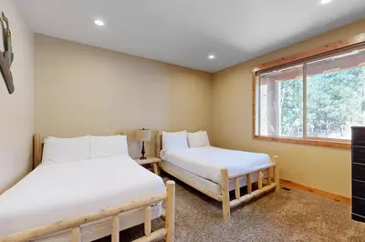 two beds in a room with a window at Marshall Escape in South Lake Tahoe