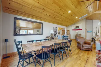 a dining room with a large wooden table and chairs at Pine Haven in Kings Beach
