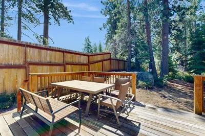 a wooden table and chairs on a wooden deck at Pine Haven in Kings Beach