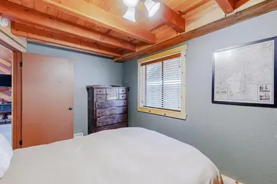 a bedroom with a white bed and a window at Cabin Oasis in Tahoma