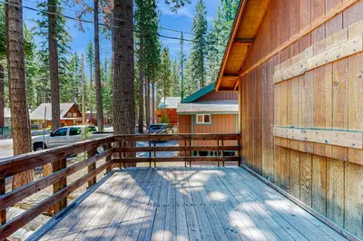 a wooden deck with a fence and a house at Cabin Oasis in Tahoma