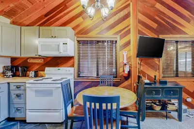 a kitchen with a table and a stove top oven at Cabin Oasis in Tahoma