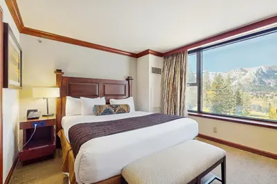 a hotel room with a bed and a large window at Resort at Squaw Creek's 560 & 558 in Olympic Valley