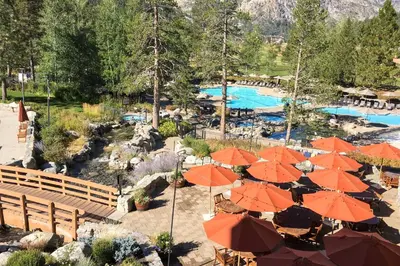 a resort with orange umbrellas and a swimming pool at Resort at Squaw Creek's 560 & 558 in Olympic Valley