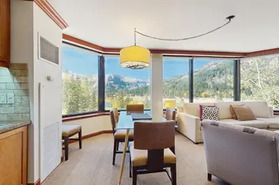 a living room with a couch and a table with chairs at Resort at Squaw Creek's 560 & 558 in Olympic Valley