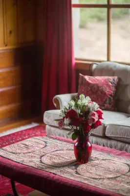 a vase with flowers on a table in a living room at Quiet Mind Lodge, Spa & Retreat Sequoias in Kernville
