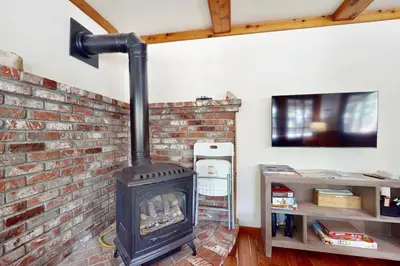 a fireplace in a room with a brick wall at Carnelian Bay Paradise in Carnelian Bay
