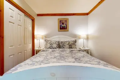 a bedroom with a large bed with two lamps at Carnelian Bay Paradise in Carnelian Bay