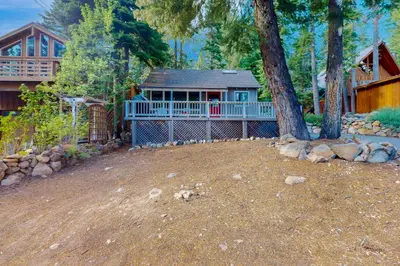 a house with a large porch and a tree at Carnelian Bay Paradise in Carnelian Bay
