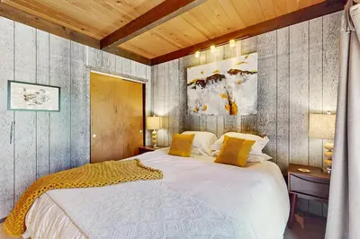 a bedroom with a large white bed with yellow pillows at Simplon Pass Escape in Homewood