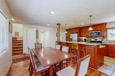 a kitchen with a wooden table and wooden cabinets at Lone Indian Charms in South Lake Tahoe