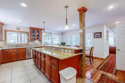 a kitchen with wooden cabinets and a large island at Lone Indian Charms in South Lake Tahoe
