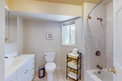 a white bathroom with a toilet and a shower at Lone Indian Charms in South Lake Tahoe