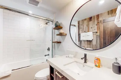 a bathroom with a sink and a mirror at Ski-In, Ski-Out Designer Condo in Truckee