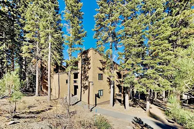 an old house in the middle of a forest at Ski-In, Ski-Out Designer Condo in Truckee
