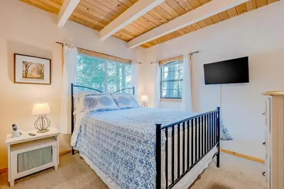 a bedroom with a bed and a flat screen tv at Cabin in the Woods in Tahoma