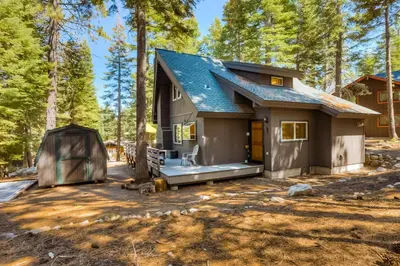 a tiny house with a tent in the woods at Cabin in the Woods in Tahoma