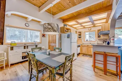 a kitchen with a table and chairs in a room at Cabin in the Woods in Tahoma