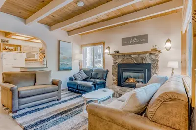 a living room with couches and a fireplace at Cabin in the Woods in Tahoma