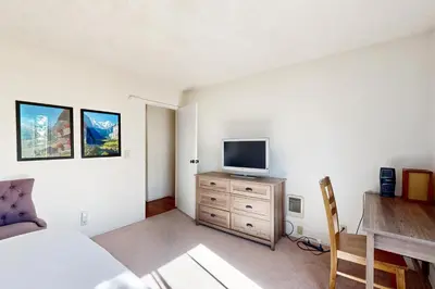 a bedroom with a bed and a television on a dresser at Ski Bowl Condos Unit 518 in Truckee