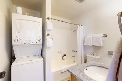 a bathroom with a washer and dryer next to a sink at Ski Bowl Condos Unit 518 in Truckee