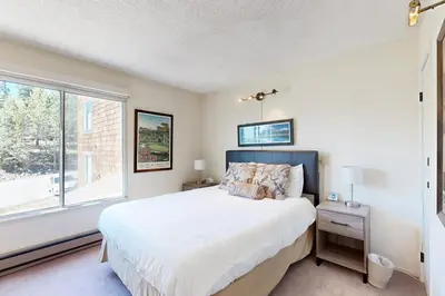 a bedroom with a large bed and a window at Ski Bowl Condos Unit 518 in Truckee