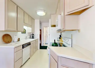 a kitchen with white cabinets and white appliances at The Summit E3 in South Lake Tahoe