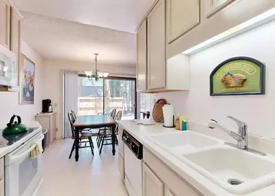 a kitchen with a sink and a table with chairs at The Summit E3 in South Lake Tahoe