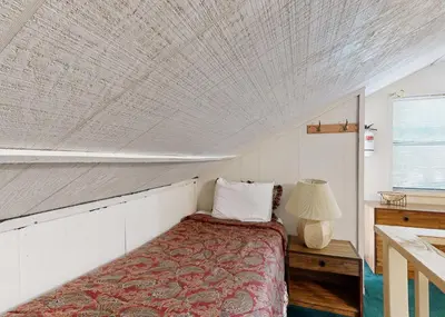 a bedroom with a bed and a table with a lamp at The Summit E3 in South Lake Tahoe