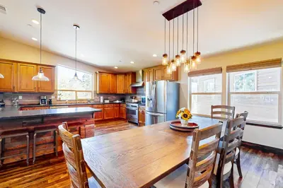 a large kitchen with a wooden table and chairs at Pooewin Place in South Lake Tahoe