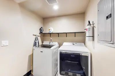 a small laundry room with a washer and dryer at Pooewin Place in South Lake Tahoe