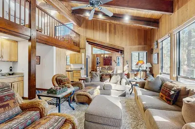 a living room with couches and a ceiling fan at Northstar Home in Truckee