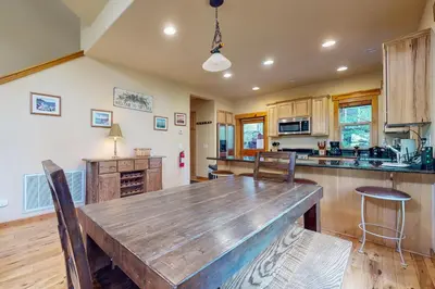 a kitchen with a large wooden table and chairs at Kimque Dreams in Truckee