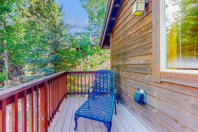 a blue bench sitting on a porch with a window at Kimque Dreams in Truckee