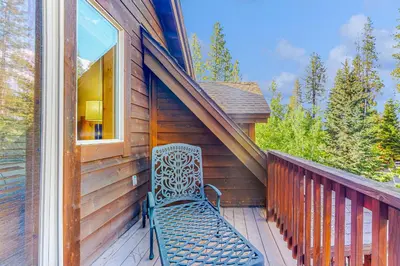 a bench sitting on the porch of a house at Kimque Dreams in Truckee